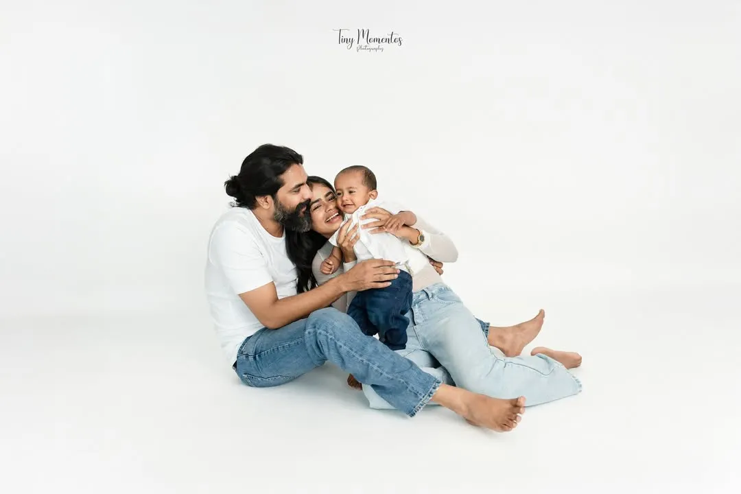 Wrapped in love. These quiet, candid family portraits on a clean white backdrop put all the focus on your family's unique connection.