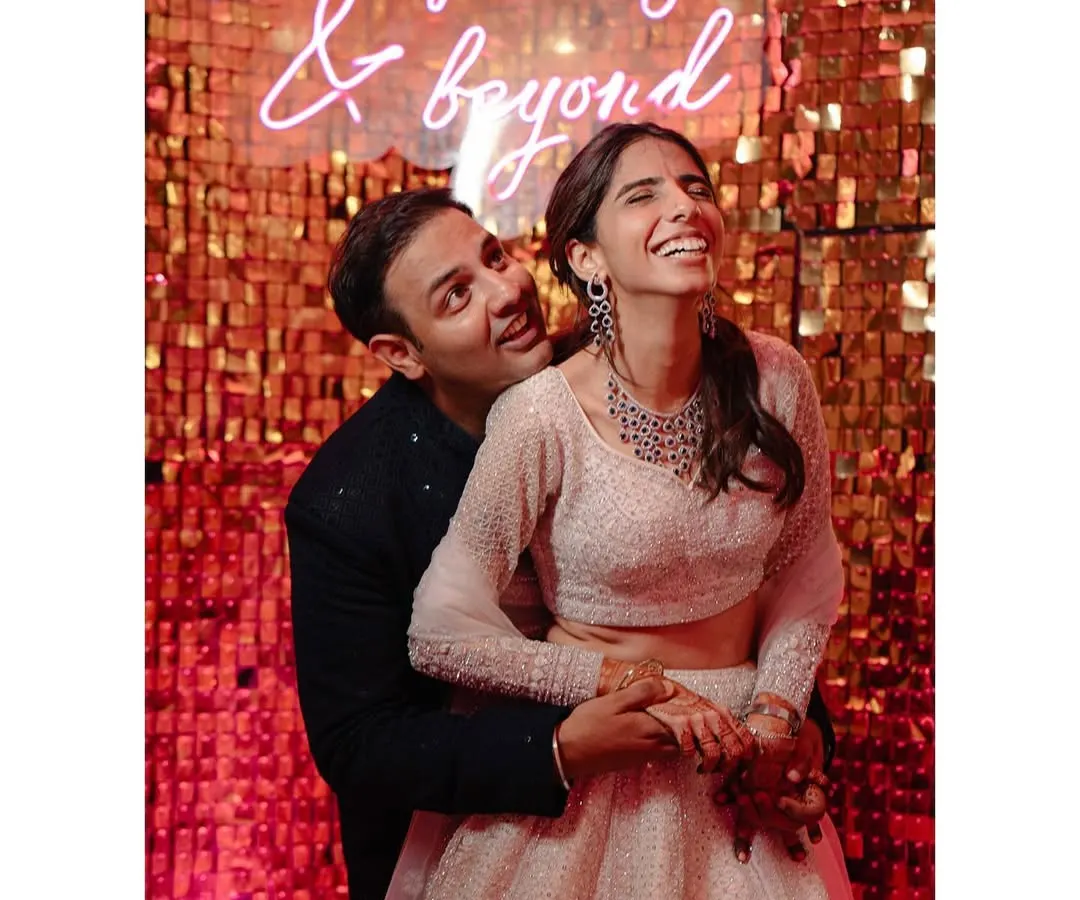 We love the pure, uninhibited joy of a wedding celebration. This moment with Shraddha and Mandela, laughing under a neon sign that says it all, perfectly captures the fun, modern, and slightly mad energy we love to document.