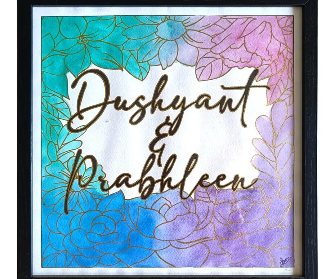I love bringing two names together in a single piece of art. This custom watercolor nameplate for Dushyant and Prabhleen was created with a floral border and blended background, making it a unique piece of home decor that celebrates their bond.