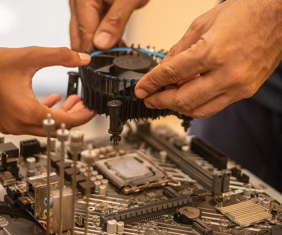 This is what real engagement looks like. We guide students as they handle complex components like motherboards and cooling fans, demystifying the technology inside a gaming PC and building their confidence with every part they install.