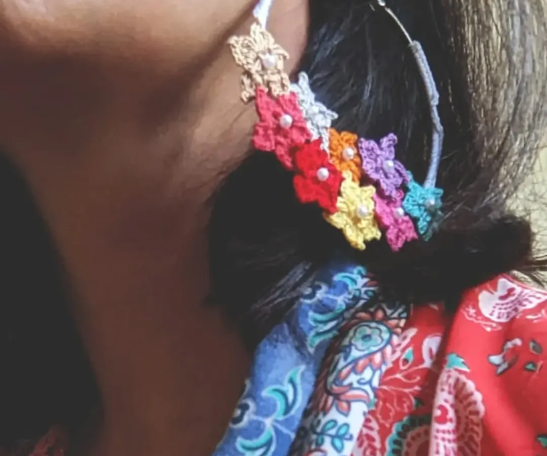 We love adding a pop of color with these floral crochet hoop earrings. They are incredibly lightweight and feature a cascade of multi-colored, handmade flowers, making them comfortable enough to wear all day.