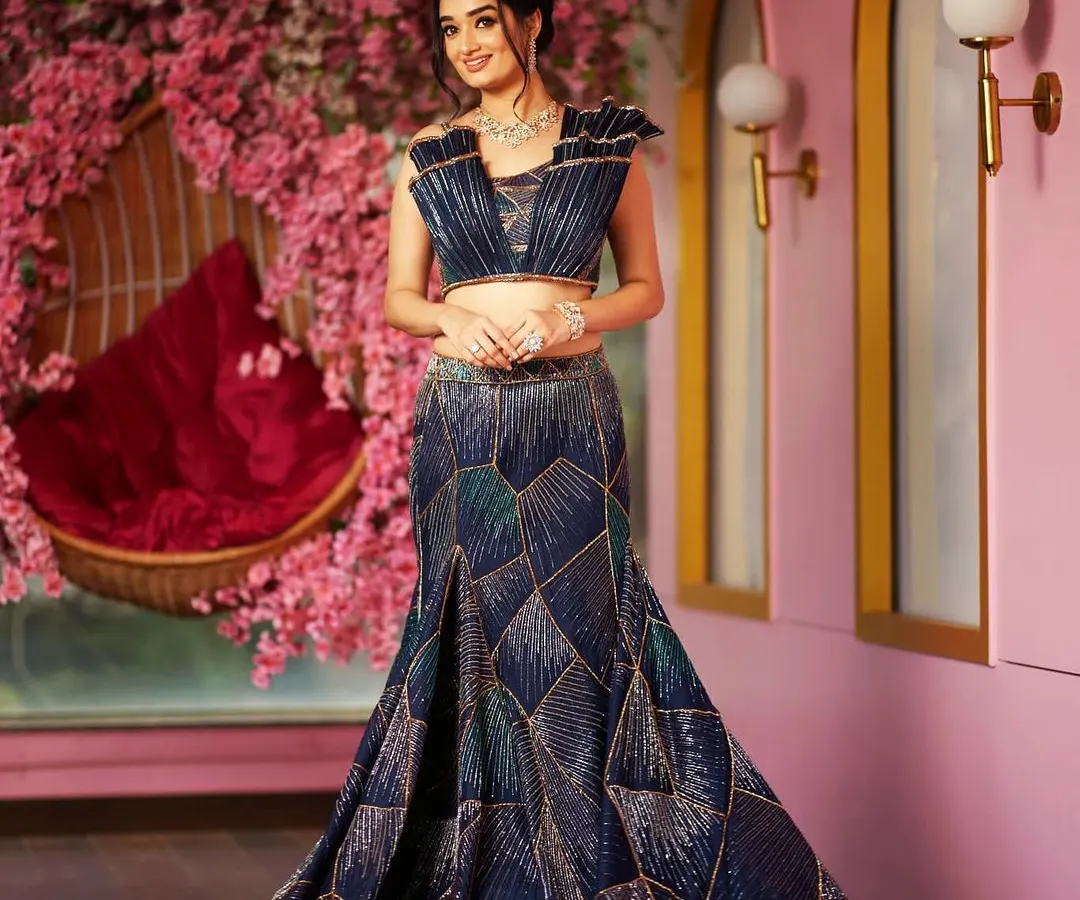For the modern bride who loves a dramatic silhouette, I designed this sculpted skirt and 3D embroidered blouse. The geometric patterns and corded cut dana work create a stunning, new-age look that is perfect for a reception or cocktail event.