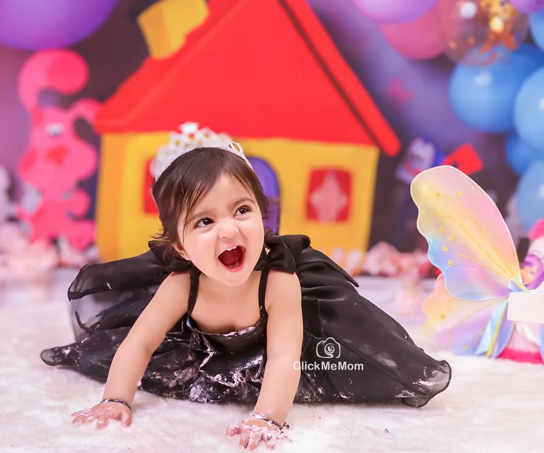 Let the mess begin. A first birthday cake smash is all about letting go and embracing the chaos, and this little princess's joyful expression says it all.