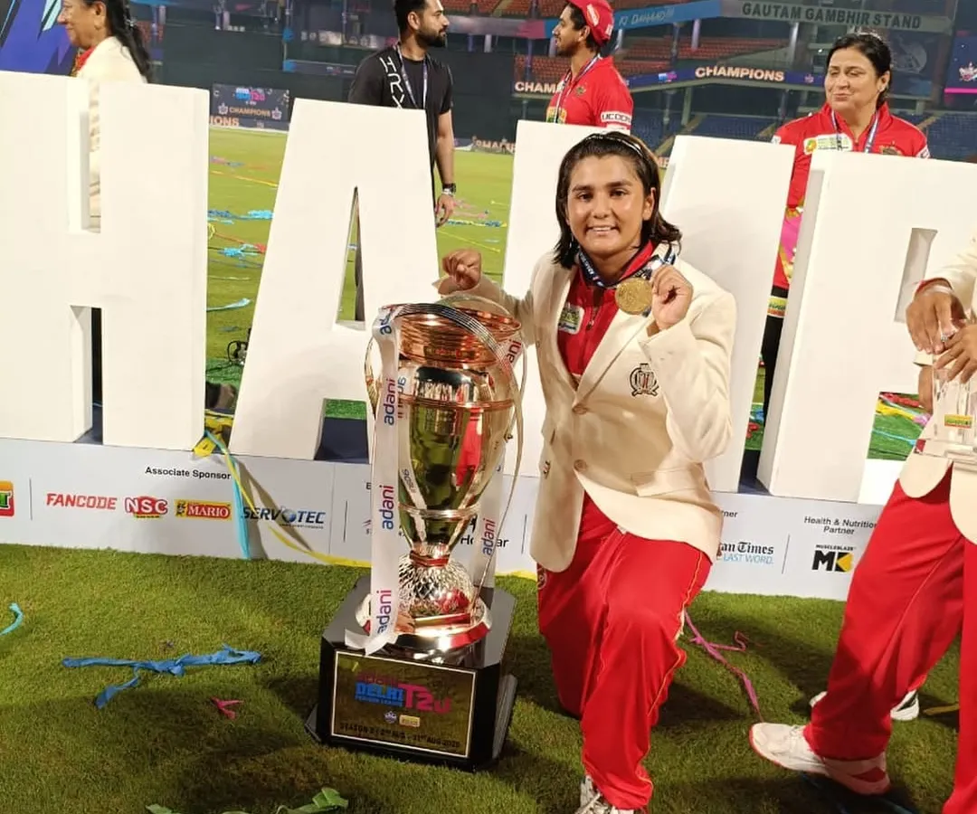 A champion's moment for Tanisha, holding the Delhi Premier League (DPL) trophy. Her success with the South Delhi Superstarz shows the high level our players are competing at and winning.