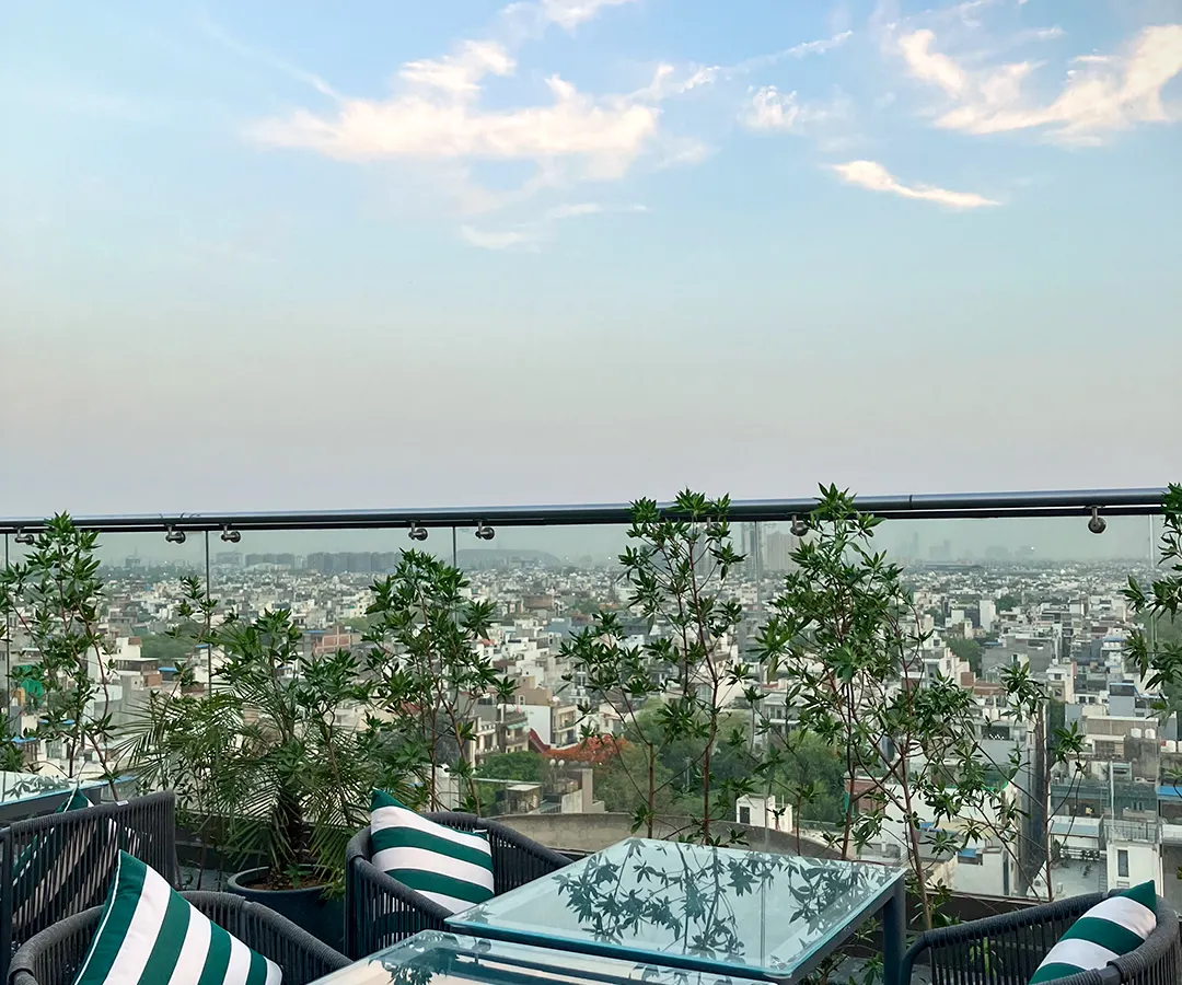 This is the view from Nakshatra, our rooftop restaurant. We've set the table for an unforgettable evening overlooking the city skyline, where the ambiance is as captivating as the cuisine.