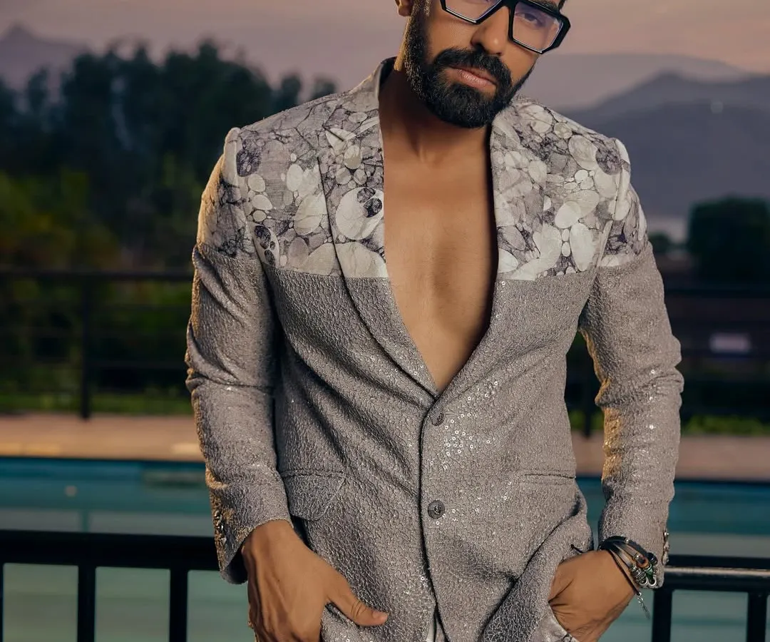 This is where modern style meets fearless design. We crafted this sequined and floral-printed co-ord set for the man who isn't afraid to be the center of attention. It's a perfect example of our fusion wear, blending contemporary silhouettes with dramatic textures for parties and cocktail events.