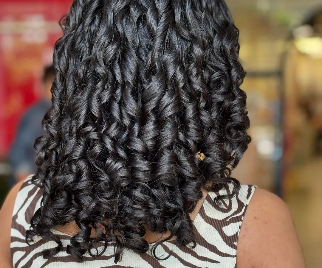 Look at the definition and shine on these curls. As a certified curl expert, I specialize in bringing curly hair back to life. This result was achieved with a custom cut and a deep hydrating treatment to make each curl pop.