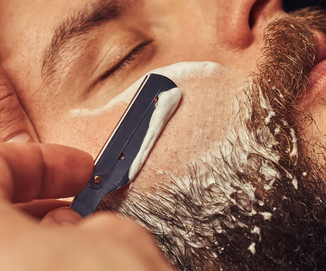 Experience the classic straight razor shave, a ritual of refinement. We use hot towels and premium balms to deliver an impeccably close and comfortable shave, leaving your skin smooth and revitalized.
