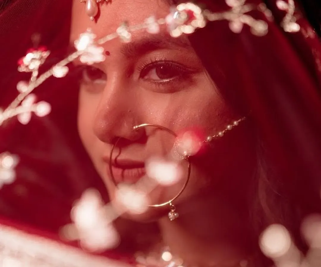 A bridal portrait is about capturing a feeling. Here, I focused on an intimate close-up, highlighting the delicate embroidery on the red veil and the traditional nath jewelry, creating a timeless and emotional shot for the bride.
