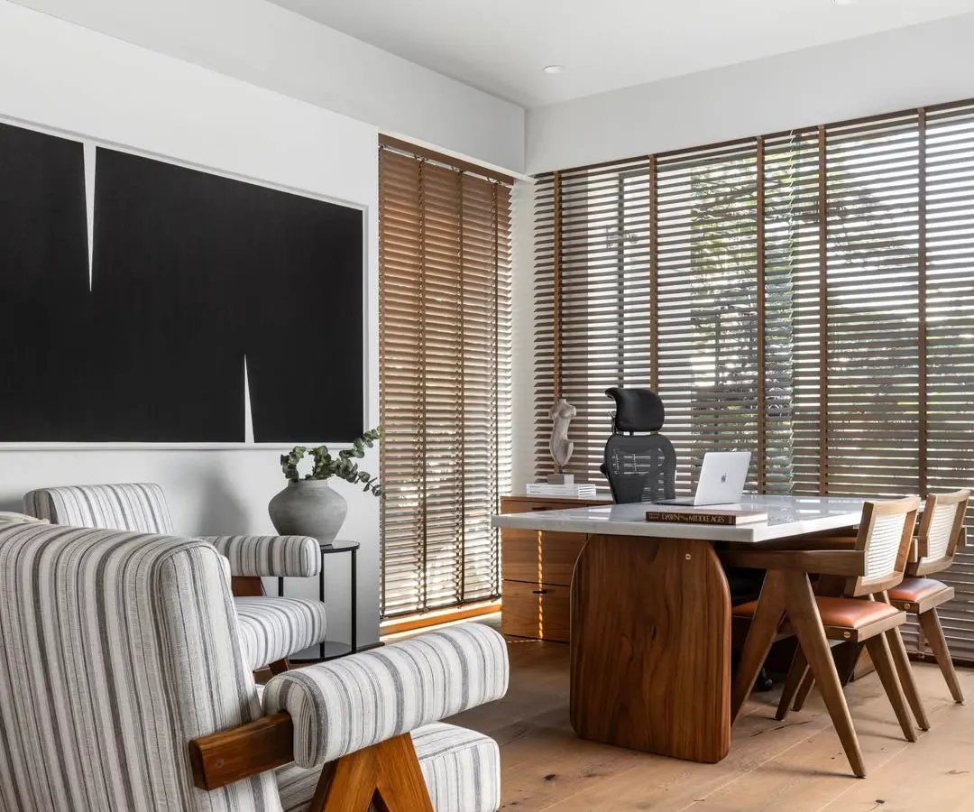 We designed this Director's Cabin as a sanctuary for focus and inspiration. The space balances authority and comfort, using a palette of warm oak, crisp whites, and bold, custom-made black artwork. Natural light filters through wooden blinds, creating a calm atmosphere that is both professional and deeply personal.
