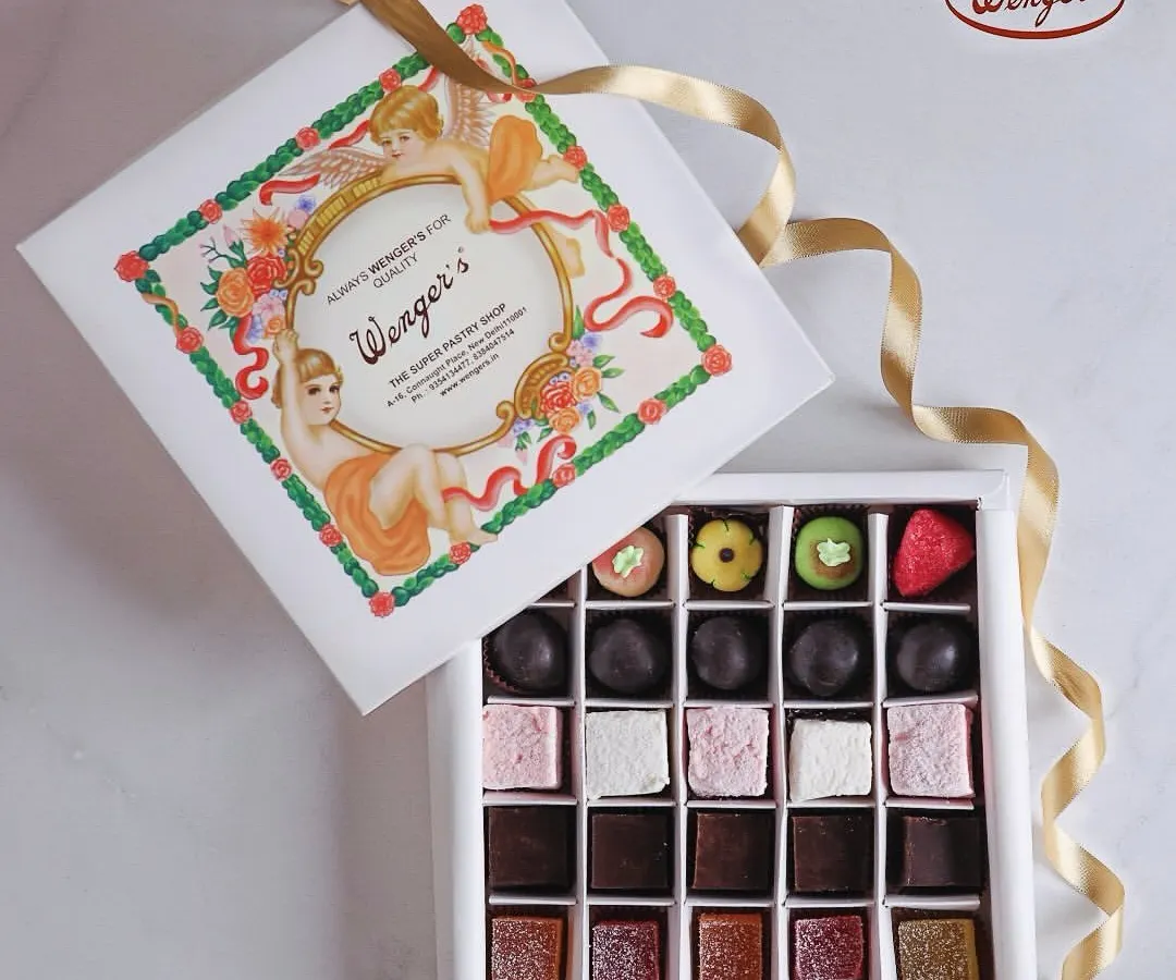 Our iconic white box is a little box of happiness. Here it is, filled with an assortment of our handmade confections, including colourful marzipan fruits, soft marshmallows, rich fudge, and classic chocolate truffles.