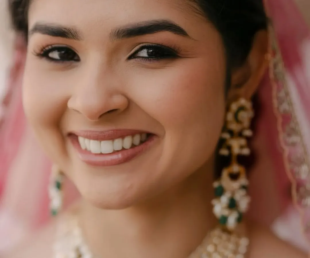 The essence of my philosophy is makeup that enhances, not masks. This close-up shows the soft glam look I love: luminous skin, subtly defined eyes with a warm, neutral shadow, and perfectly groomed brows. It’s about looking like the best version of yourself.