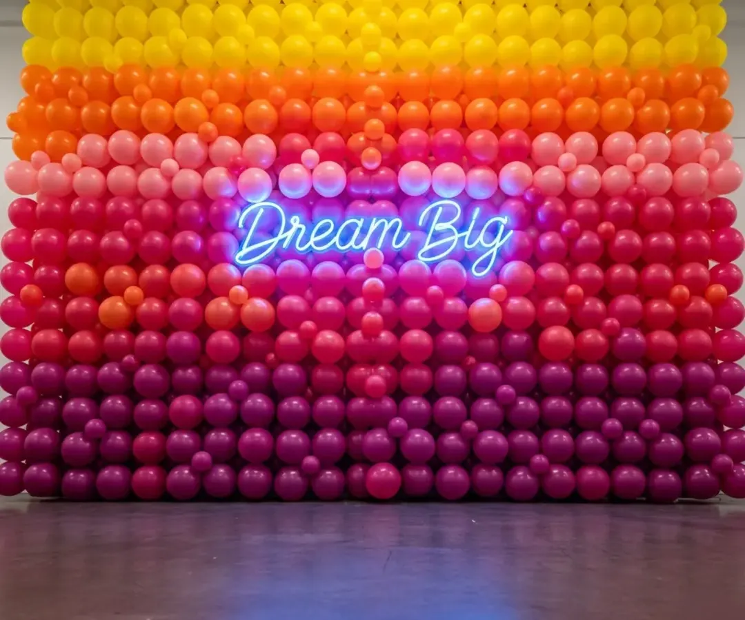 This custom balloon wall was the star of a recent brand activation event. I used an ombre color scheme to match the client's branding and added a 'Dream Big' neon sign to create the perfect photo opportunity. It's a great way to boost engagement at your conference or launch.