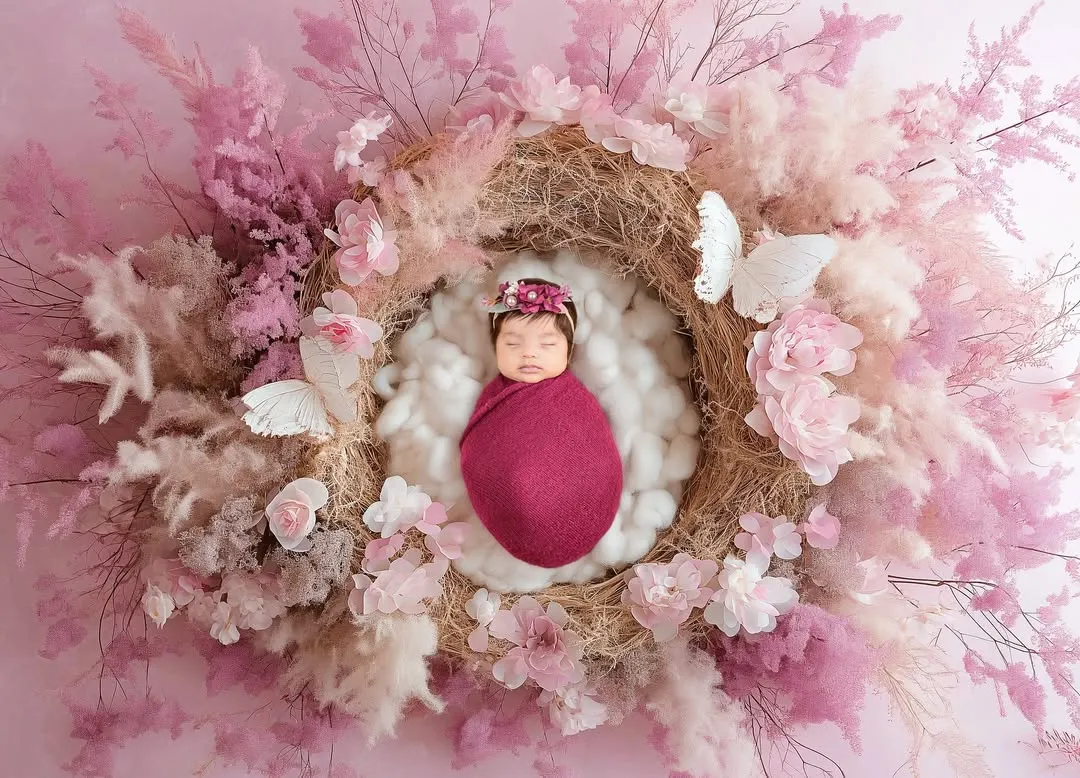 There is nothing as pure and peaceful as a sleeping newborn. For this newborn portrait, I created a delicate nest of pink flowers and soft textures to keep this little angel cozy and safe.