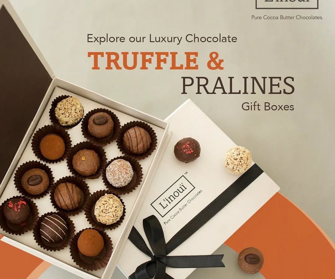 Our luxury truffle and praline gift box, opened to reveal an assortment of handcrafted chocolates. This is our most popular gift, perfect for celebrating anniversaries, promotions, or simply showing appreciation with a truly decadent treat.