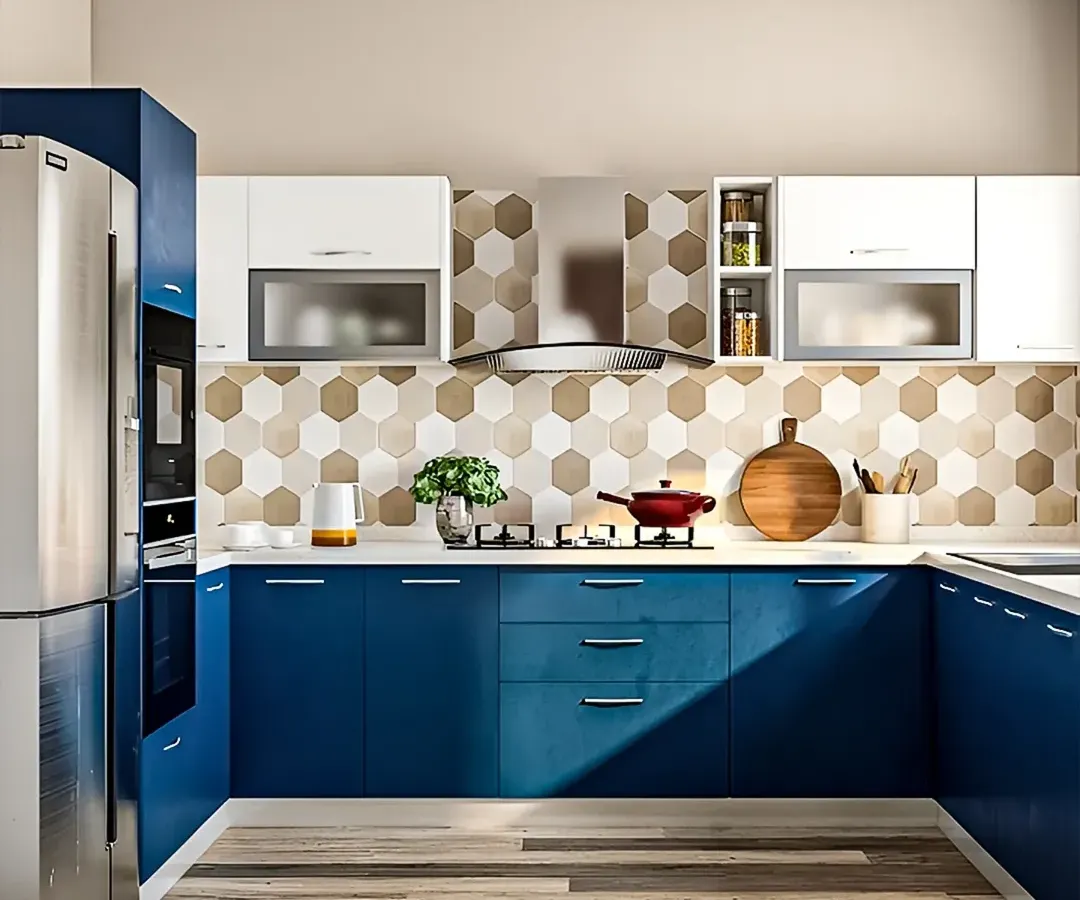 This U-shaped modular kitchen is designed for efficiency and style. The bold blue cabinetry is paired with a geometric honeycomb backsplash and crisp white countertops, creating a vibrant and highly functional cooking space with ample storage.