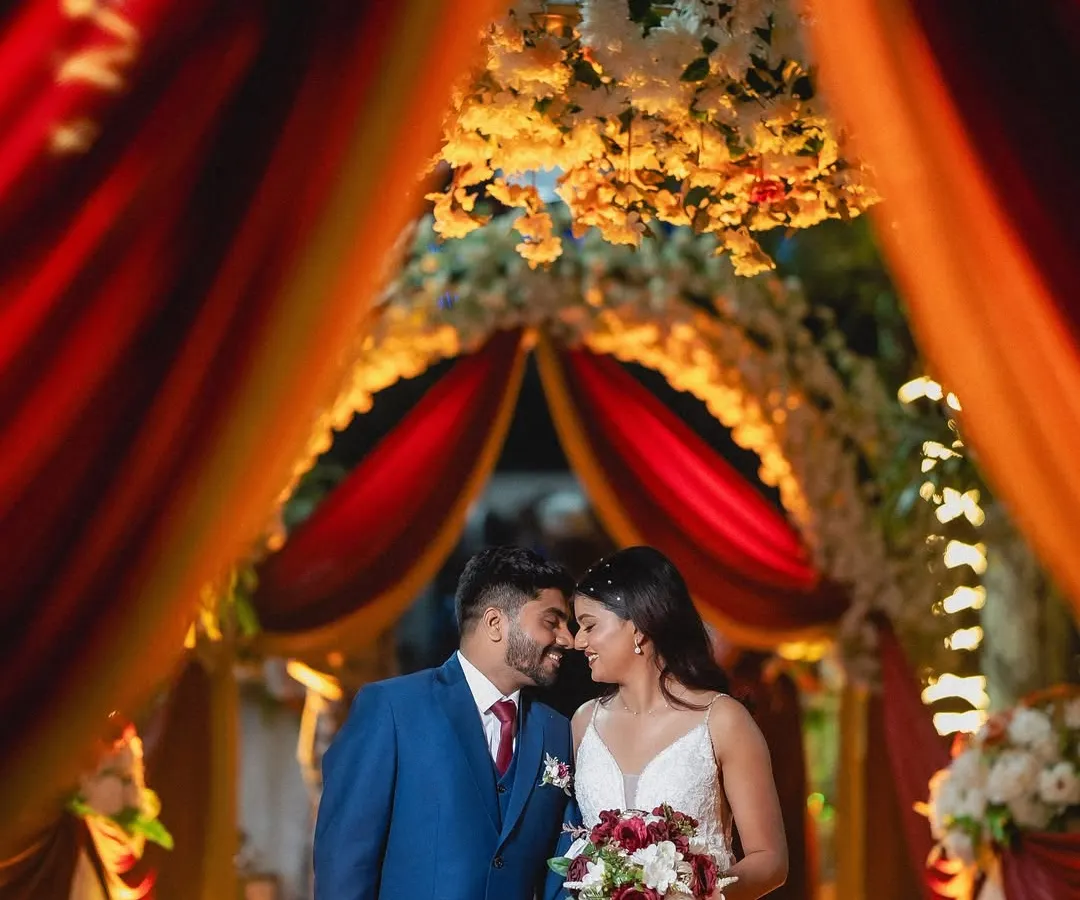 A quiet moment for the couple under a beautifully decorated archway at their reception. I focus on using ambient light and decor to frame these romantic wedding portraits.
