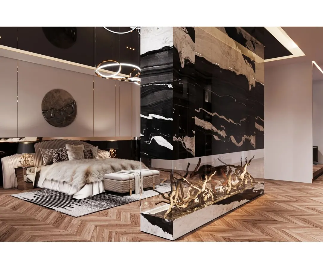 This master bedroom is designed as a luxurious retreat. We incorporated a statement fireplace with a dramatic black and gold marble finish, creating a stunning focal point. The design balances bold textures with soft, comfortable furnishings for a truly unique personal sanctuary.