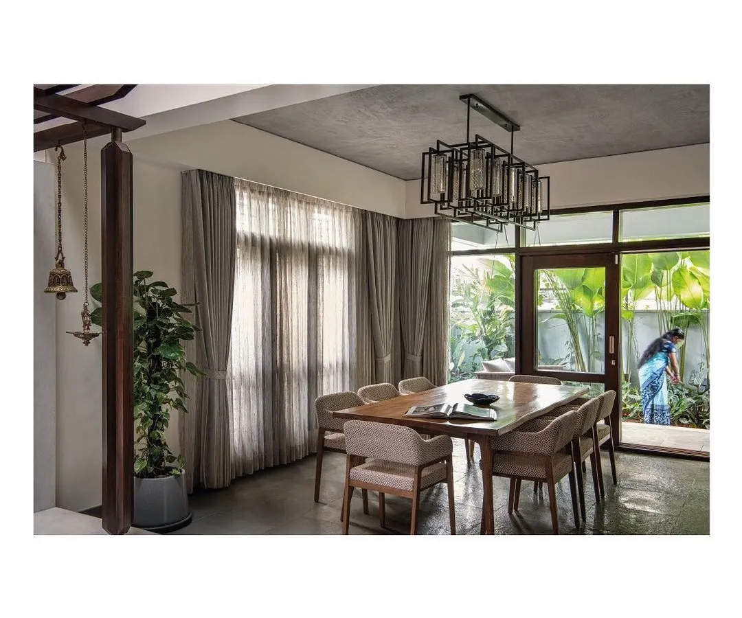 The dining area at the Nairy residence, featuring a custom solid wood dining table and upholstered chairs. The design emphasizes clean lines and material integrity, creating a functional and elegant space that connects seamlessly with the outdoors.