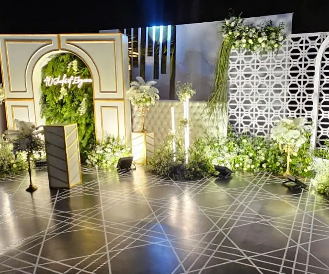 I believe in creating breathtaking settings for your events. This elegant stage for a corporate gala features a lush green wall, modern architectural arches, and a custom geometric floor design, setting the scene for a night of celebration.