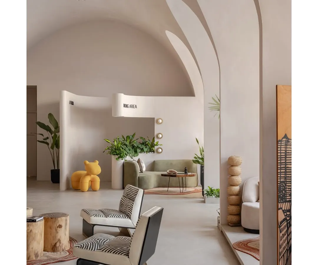 Welcome to the 'Vaultz's Up' experience centre, where we've created a modern sanctuary inspired by the serene caves of Santorini. The space is defined by its grand, intersecting vaults and a minimalist palette, creating a tranquil yet dramatic atmosphere.