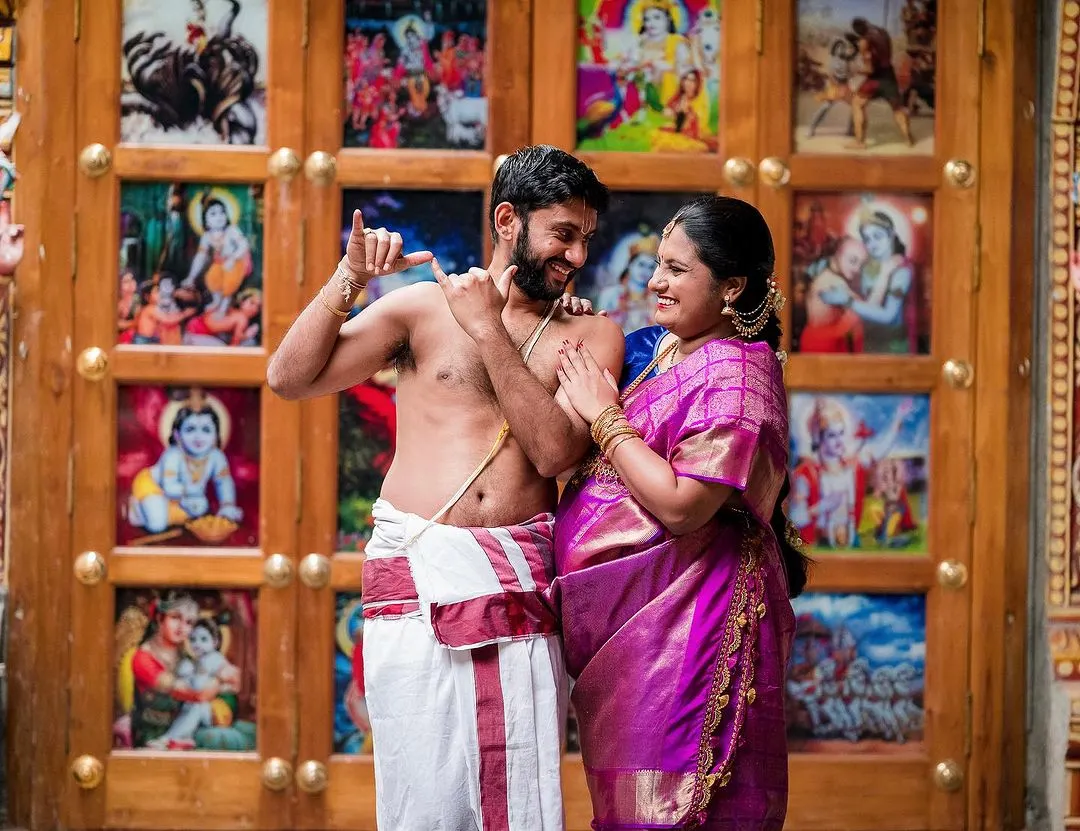 A playful moment during a maternity shoot at a temple, celebrating the couple's journey to parenthood. We focus on capturing the joy and connection between partners as they await their new arrival.