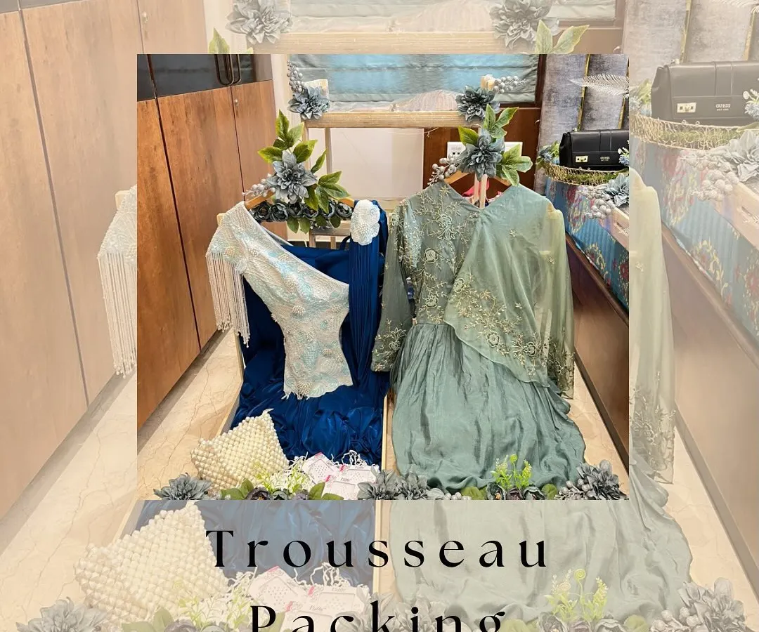 We believe a trousseau should be a work of art. Here, we've created an elegant display for the bride's outfits, using a beautiful wooden structure and delicate floral arrangements to turn her collection into a stunning showcase.