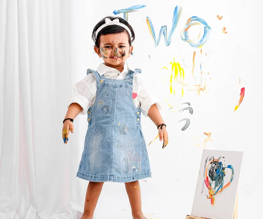 Let them be little and let them be messy! This fun paint-splatter theme for a second birthday shoot is all about capturing the pure, uninhibited joy of childhood creativity.