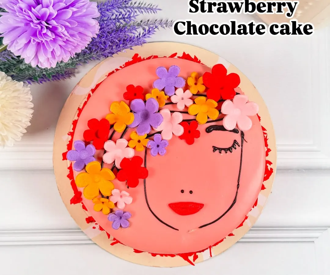 Celebrate the amazing women in your life with our special Strawberry Chocolate cake. This beautifully decorated cake features a delicate floral design on a rich, flavorful base, making it the perfect centerpiece for Women's Day.