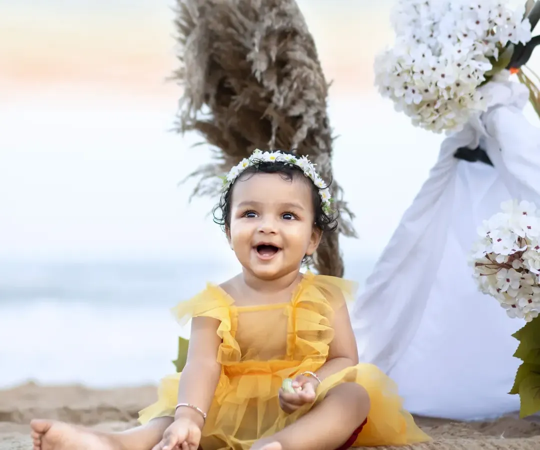 There's something magical about a baby's laughter by the sea. For this beach milestone session, we used the golden hour light and a simple, breezy setup to capture this little one's radiant smile.