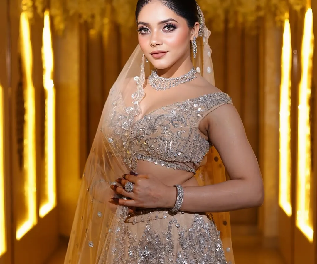 For a modern reception or engagement, I often create looks like this. It features soft, glowing skin, subtly smoked-out eyes, and a neutral matte lip, paired with a sleek, elegant bun. The diamond jewelry and shimmering lehenga complete this sophisticated and contemporary bridal style.