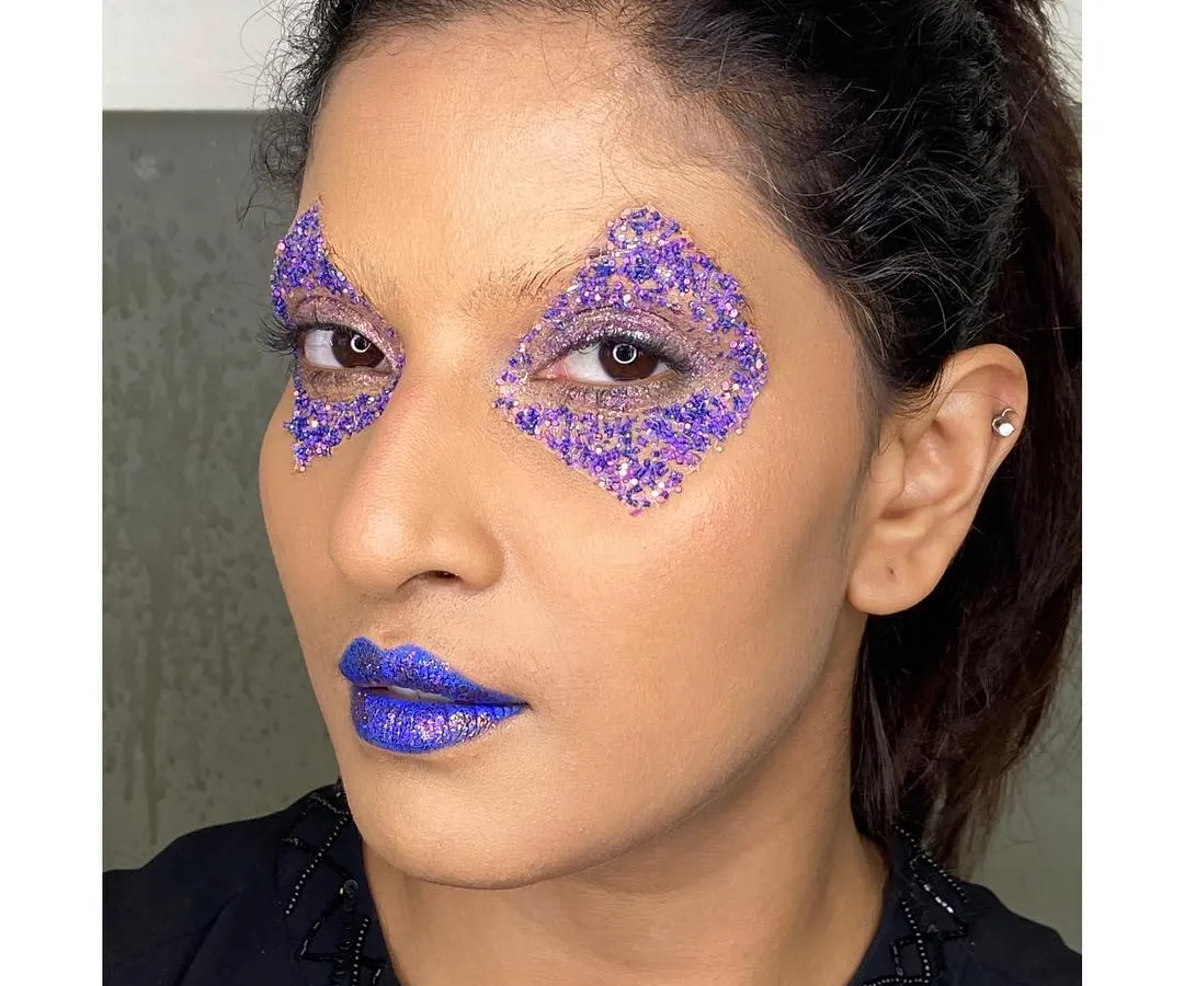 Creating sharp, geometric shapes with glitter is one of my favorite techniques for an edgy editorial concept. Here, I used purple glitter to craft a diamond shape around the eye, paired with a bold purple lip.