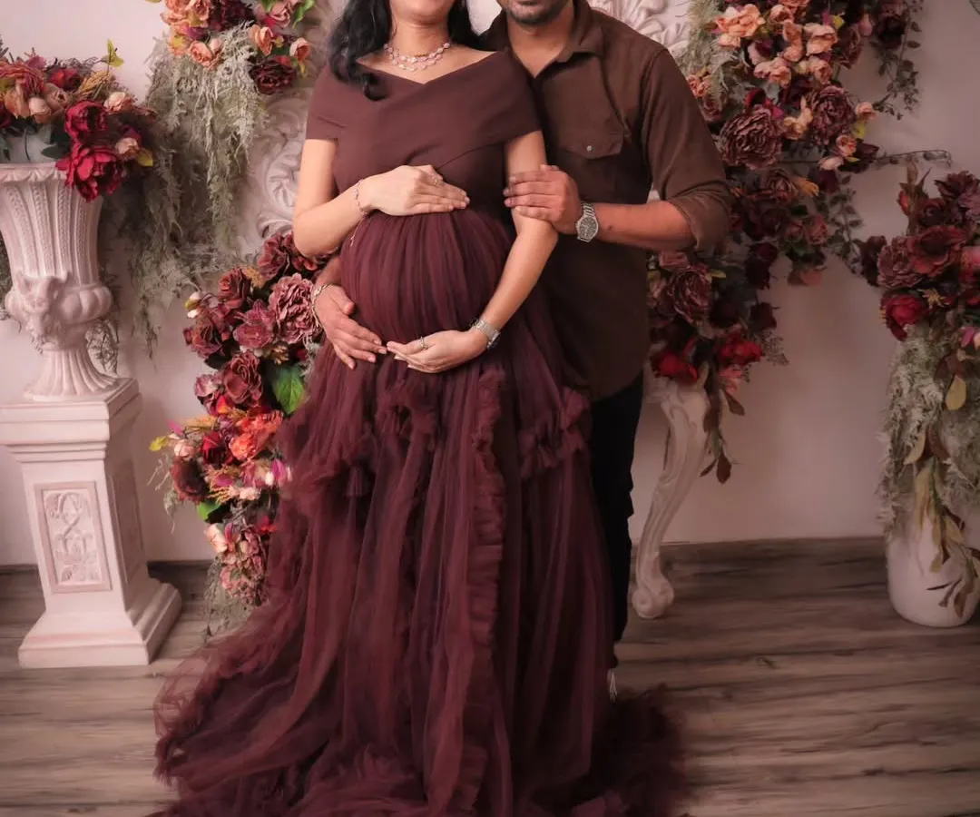 I create picture perfect moments for expecting couples. This maternity photoshoot features our rich, burgundy floral backdrop, designed to add a touch of drama and elegance to your special portraits.