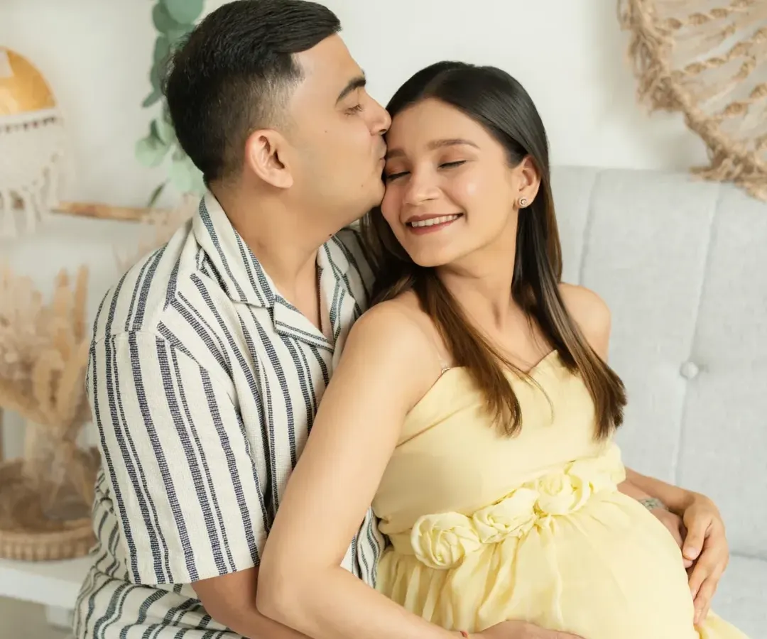 The quiet moments between partners are pure magic. In my natural light studio, I create a relaxed space for you to connect, allowing me to capture the authentic love that surrounds your growing family.