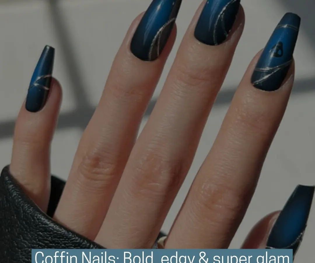 Embrace your edgy side with these bold, super glam coffin nails. This design features a deep blue matte base with intricate, shimmering silver line work, demonstrating our skill in creating dramatic and fashionable nail shapes.