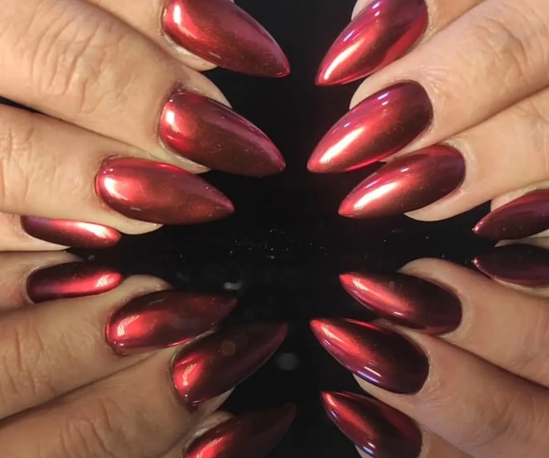Feel the heat with these fierce stiletto nail extensions, coated in a vibrant, mirror-like red chrome finish that reflects light from every angle.