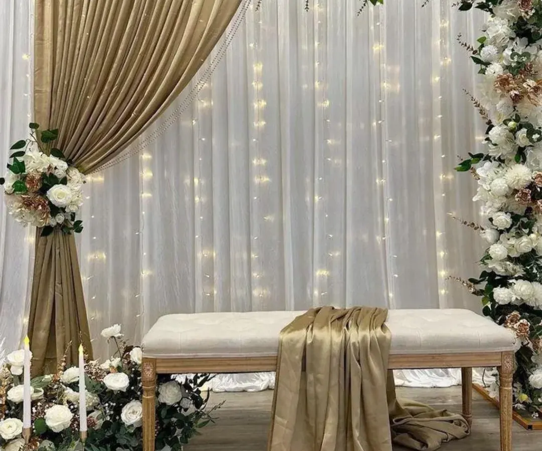 For a more elegant and sophisticated look, I created this stage with a white and gold theme. The setup includes a floral arch, soft drapery with fairy lights, and candle accents for a truly romantic feel.