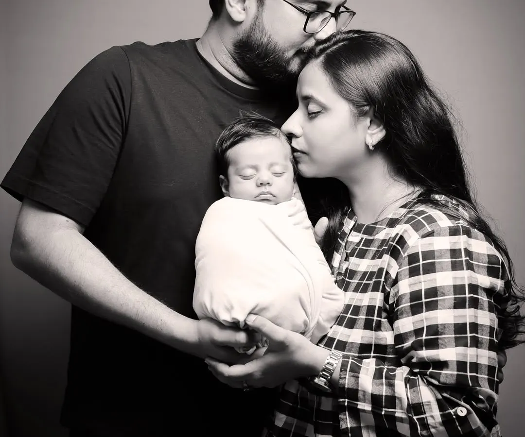 There is nothing more powerful than the love of new parents. This timeless black and white portrait captures that gentle, protective embrace during a newborn family session.