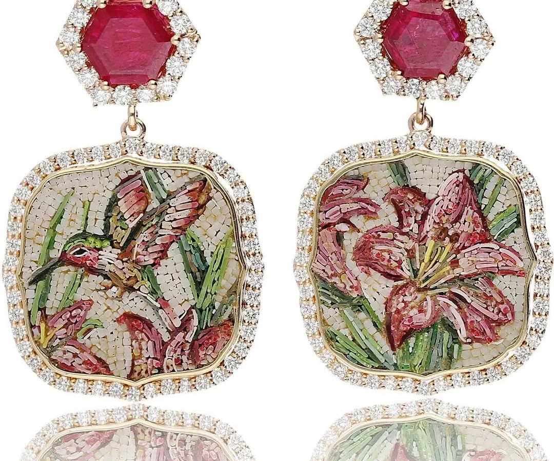 I love designing asymmetrical earrings that tell a story. This pair, named "The Promise of Eden," features a hummingbird on one side and a lily on the other, both crafted in micromosaic and set with a halo of diamonds and hexagonal rubies.