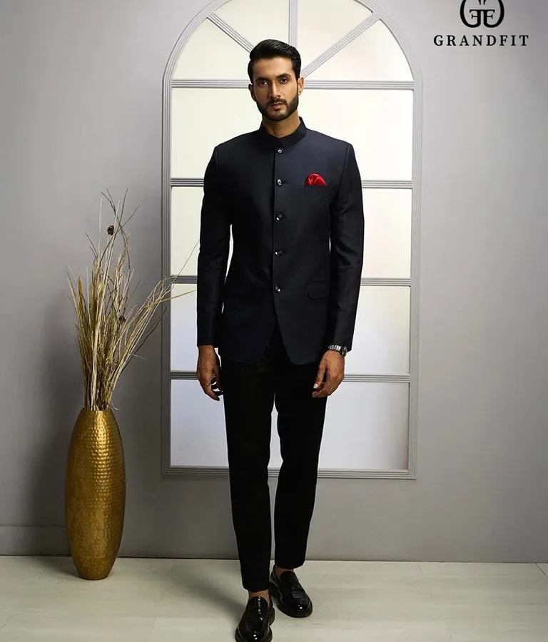 A modern interpretation of classic Indian formal wear. This bespoke navy Jodhpuri suit features a sharp mandarin collar and a clean, structured fit, perfect for weddings and distinguished celebrations.