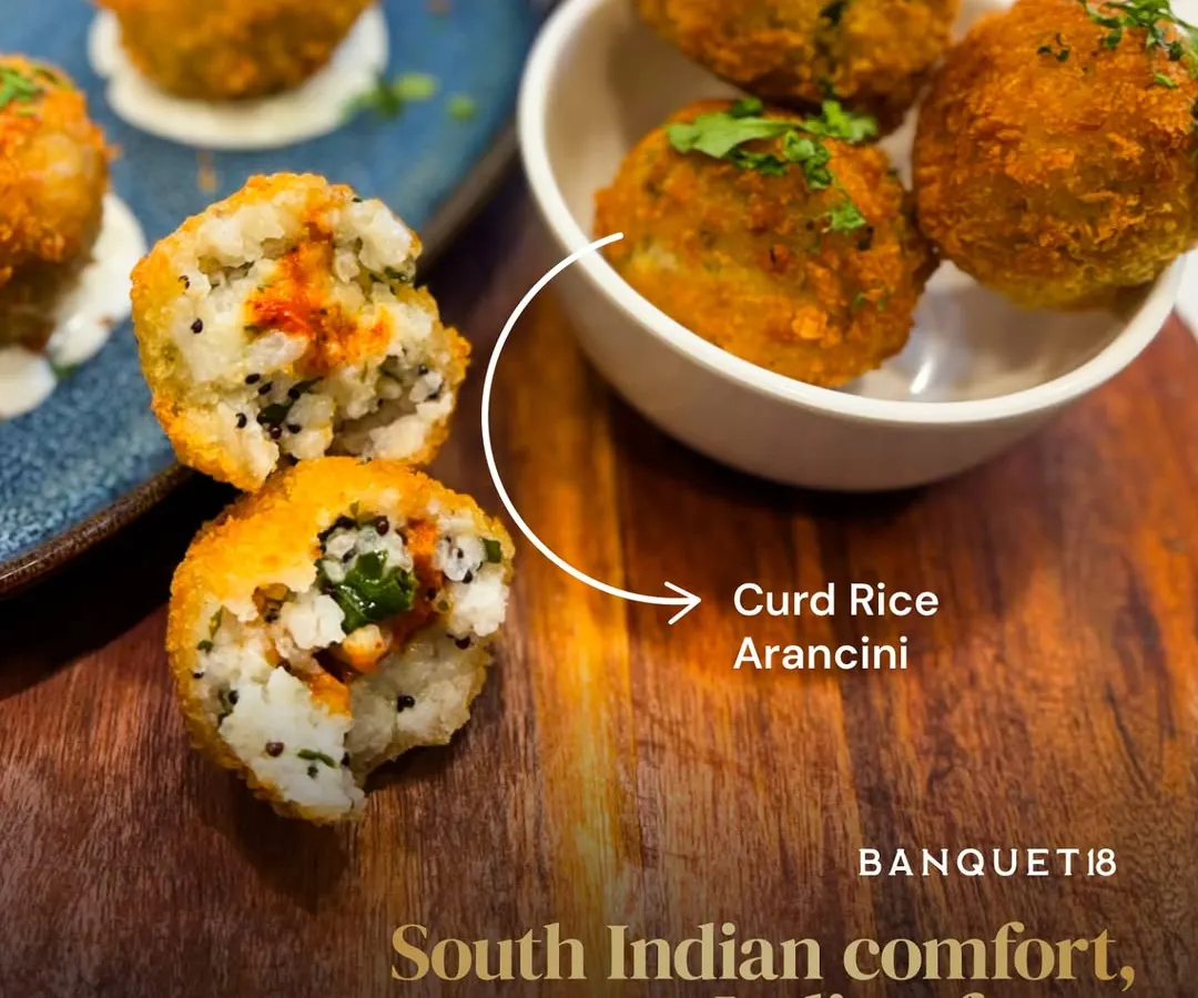 This is our Curd Rice Arancini. We took a beloved South Indian comfort food and gave it an Italian twist, creating a crisp, creamy appetizer with a surprise burst of mango pickle inside. It’s a perfect example of how we love to blend the familiar with the unexpected.