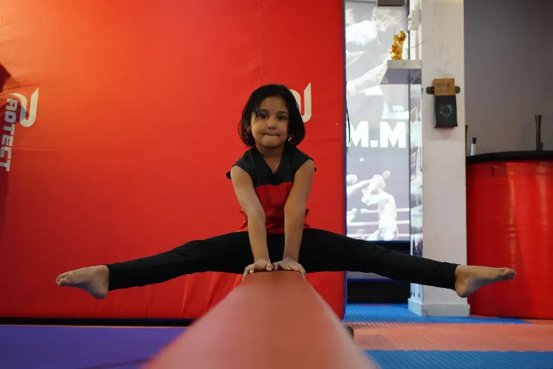 Balance, focus, and confidence on full display. Our gymnastics program helps children develop exceptional strength and flexibility, and this young athlete demonstrates the amazing results of her dedication on the balance beam.