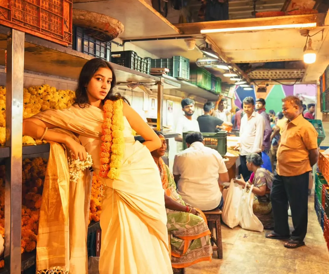 I love the contrast of high fashion in everyday places. Here, we created a striking editorial moment with a traditional saree amidst the beautiful chaos of a Mumbai flower market.