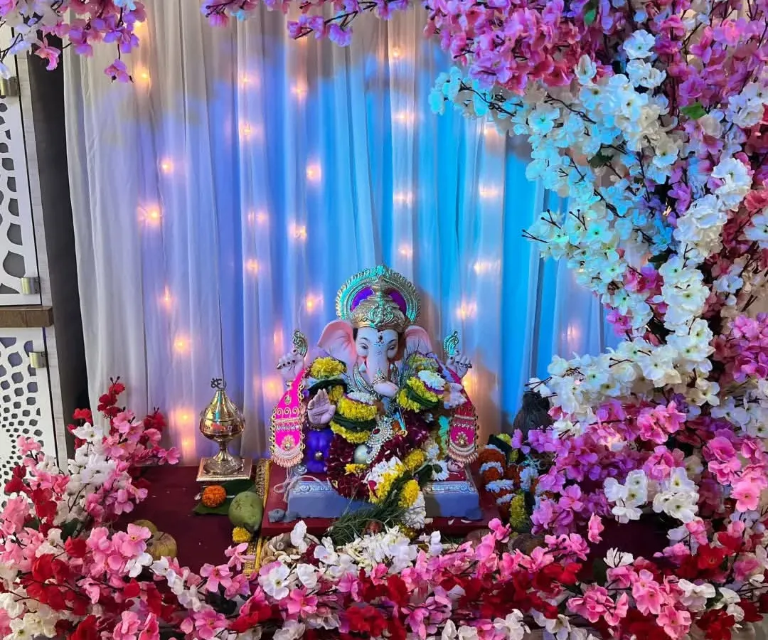 Our cherry blossom theme is a favorite for its delicate and modern look. Here, we have created a beautiful arch with pink, white, and red artificial cherry blossoms, complemented by a soft white curtain backdrop with fairy lights for a magical glow.