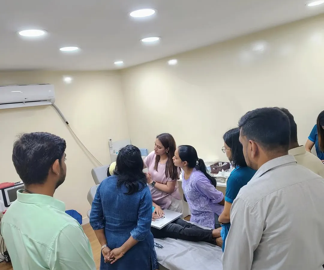 This image captures the collaborative environment of my training sessions. A group of dedicated dermatologists observes a live demonstration, fostering a space for shared learning and in-depth discussion on advanced aesthetic applications.