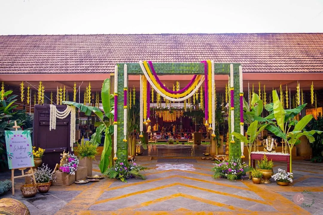 A glimpse into a traditional South Indian wedding, where every detail is steeped in culture. I designed this entrance to be grand yet welcoming, using banana stems, intricate coconut leaf weaving, and garlands of marigold and jasmine to create an authentic and auspicious atmosphere.
