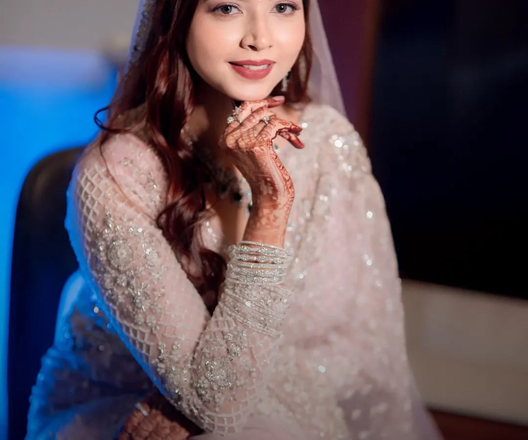 A close-up bridal portrait of Jyoti, highlighting the intricate details of her attire and the delicate henna on her hands. My goal is to capture the bride's radiance and serene beauty.
