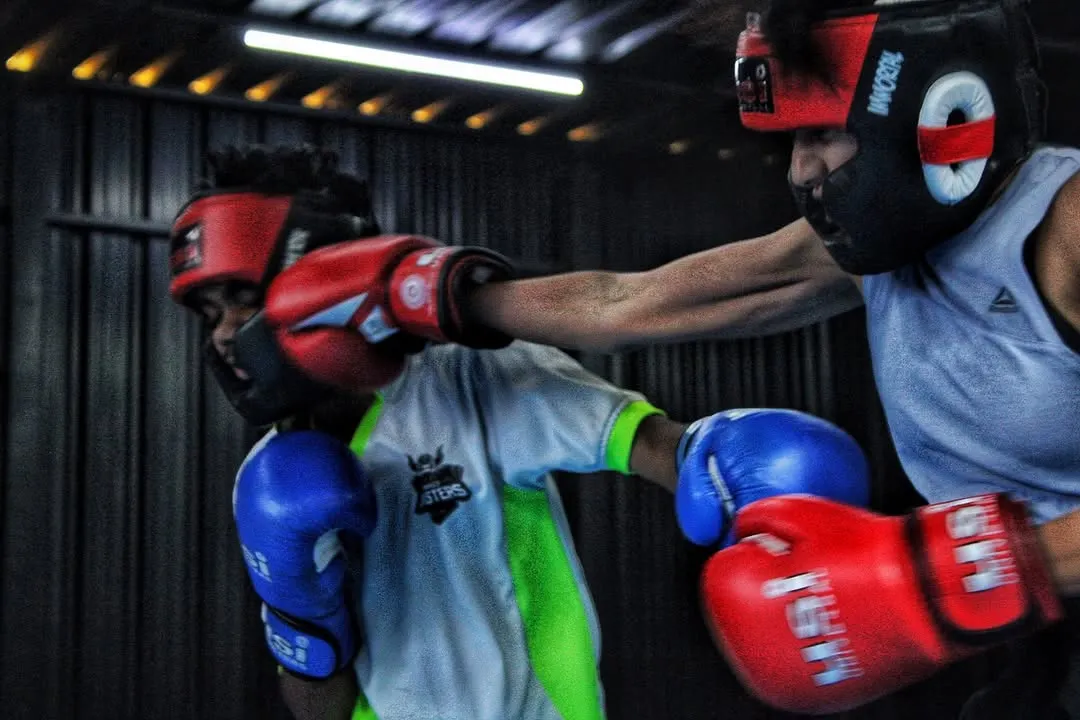 You will get hit. Here, two of our young boxers are in a controlled sparring session, learning to trade punches and think under pressure. This is how you build resilience.