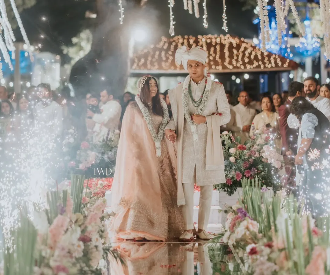 Imagine walking on water towards your forever. We designed this stunning mirror aisle, reflecting a thousand lights and the love of family, creating a magical path for the couple's journey together under a canopy of jasmine.