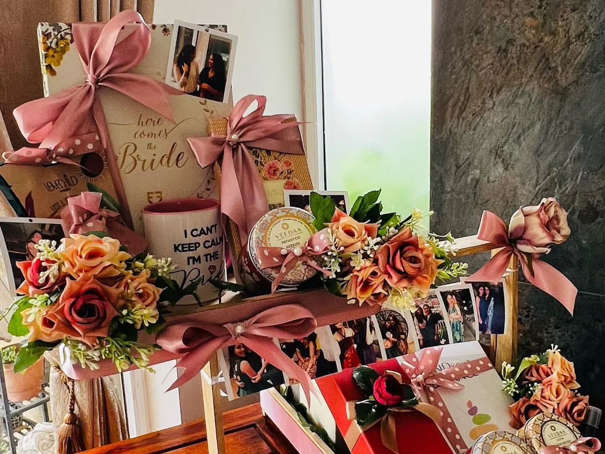 This is one of my most cherished creations, a multi-tiered wedding gift for a best friend. It features personalized elements like a photo reel of shared memories, a custom mug, and curated gifts, all unified by a soft pink and floral theme to celebrate the bride-to-be.
